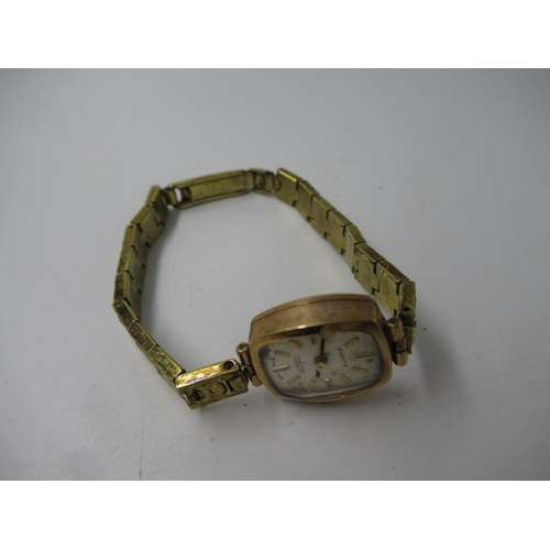 649 - Ladies 9ct gold cased wristwatch on a metal bracelet