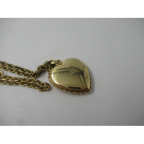 658 - 9ct Gold heart shaped locket on a 9ct gold rope link chain, 9gm