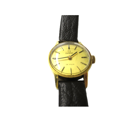 685 - Ladies 9ct gold cased Omega wristwatch with gilt dial and baton numerals, on a brown leather strap