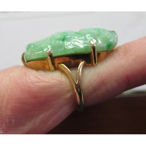 619A - 9ct Yellow gold mounted ring set with pierced and floral carved jade, size 'J'