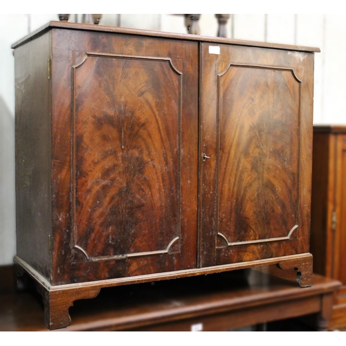 1115D - Figured mahogany side cabinet, the moulded top above a pair of moulded panel doors on bracket feet, ... 