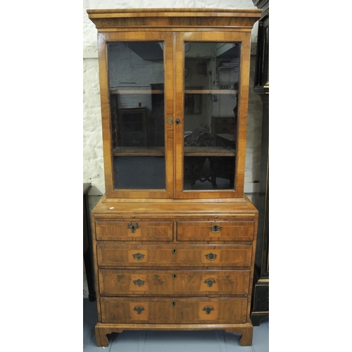 1156 - 18th Century and later walnut two door bookcase, having moulded top with adjustable shelves, the bas... 