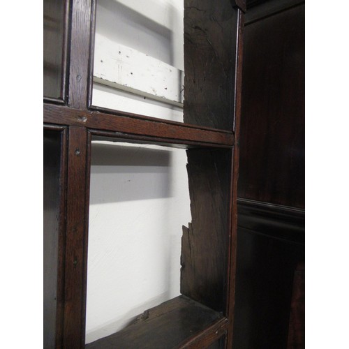 1165 - 18th Century oak dresser, the open shelved back above a moulded top with four short drawers, having ... 