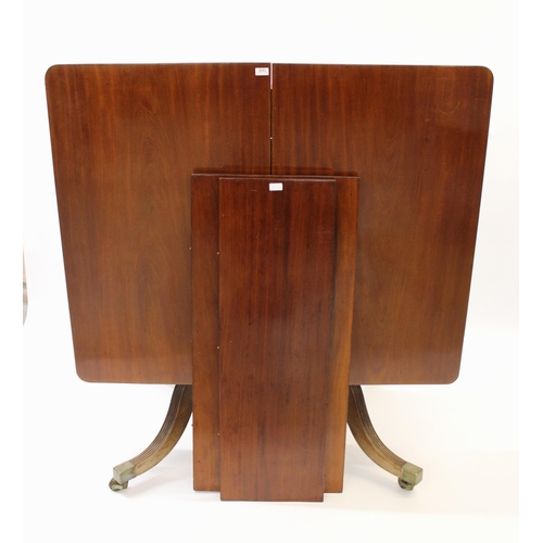 Unusual late Regency mahogany rectangular extending dining table, the tilt top above a large quadruped base with baluster turned uprights, reeded sabre legs and brass caps and casters, 132 x 108cm in the closed position, together with two additional leaves of 50cm and 34cm respectively (some alterations)