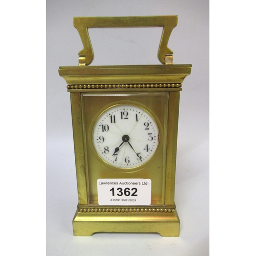 20th Century gilt brass cased carriage clock, the circular enamel dial with Arabic numerals (hairline cracks), with key, 12.5cm high