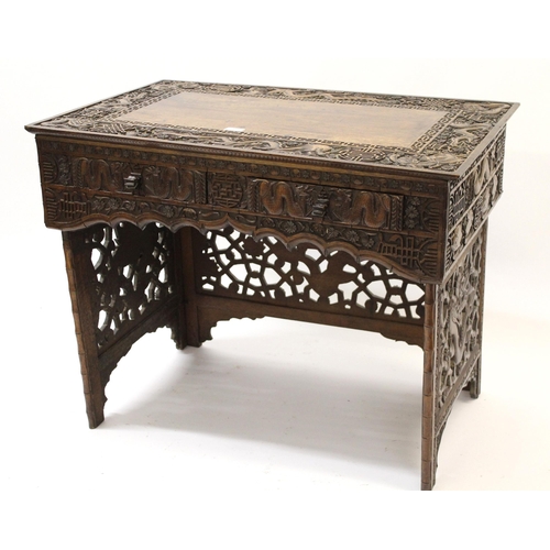 Chinese hardwood folding travel/campaign desk heavily carved with figures of dragons and emblems, 87 x 55 x 21cm folded