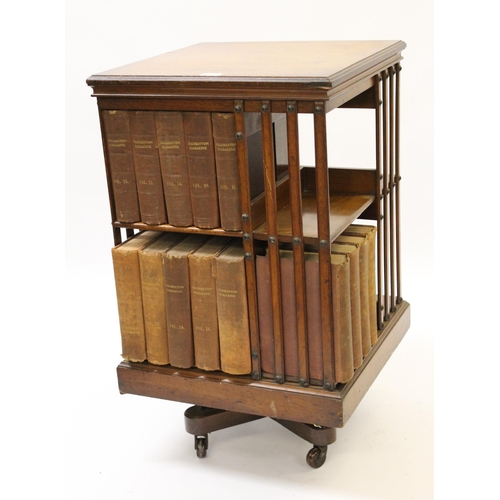 Edwardian mahogany revolving bookcase, 85cm high x 49cm square, containing a library of Badminton Magazine canvas bound books