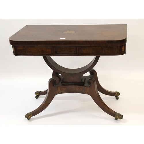 George III mahogany rosewood crossbanded and inlaid 'D' shaped card table , the foldover top with baize lined interior on a shaped base with swept feet and brass paw castors, 73cm high x 89cm wide x 44cm deep