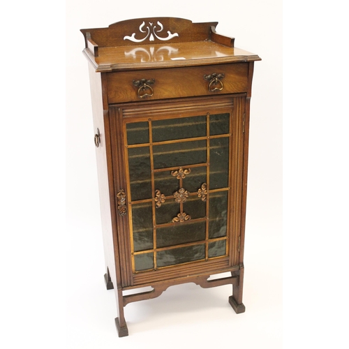 1735 - Shapland & Petter Arts and Crafts walnut music cabinet, the single door with copper glazing bars and... 