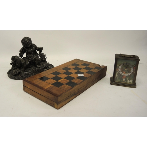 296 - Modern olive wood folding chess board with chess set, a spelter figure of a seated cherub and a mode... 