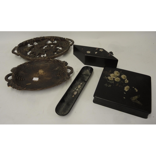 302 - Two oval Black Forest carved wooden dishes, two lacquered boxes and a pen tray