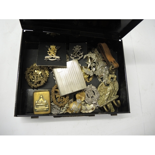 312 - Quantity of loose military cap badges etc., housed in a military issue first aid box