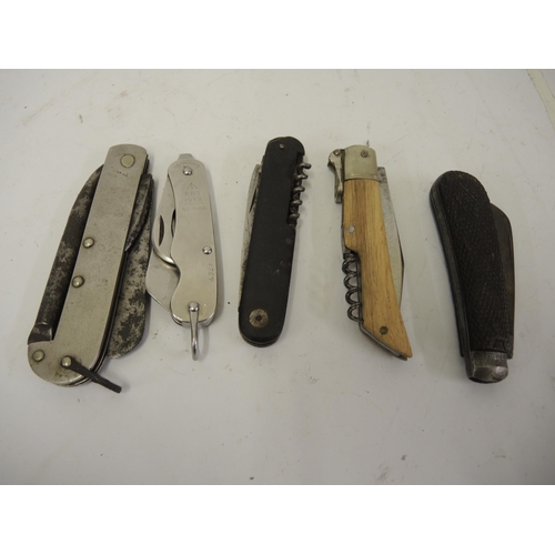 315 - Four various folding knives, including 1953 military issue and another with Solingen blades