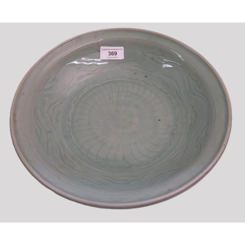 Chinese Celadon circular deep dish with shallow incised decoration, 32cm diameter, with a hardwood stand (damages)