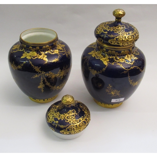 374 - Pair of Royal Crown Derby oviform vases with covers, each with gilt floral decoration on a cobalt bl... 