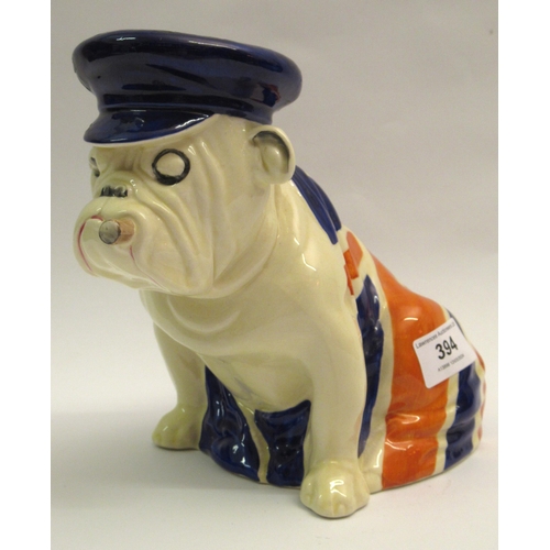 394 - Royal Doulton figure of a seated British Bulldog draped in a Union Jack (restoration to blue cap)