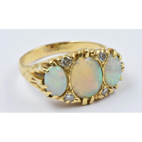 746 - Yellow gold ring set three oval opals and four diamonds, 6.6g, size O