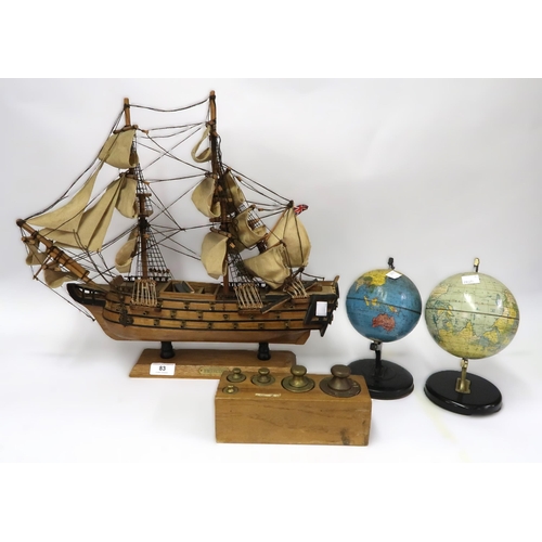 83 - Wooden model of HMS Victory, two miniature metal world globes and a set of five postal weights