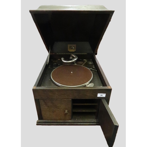 86 - HMV oak cased table model wind-up gramophone, together with a quantity 78 speed records and a quanti... 