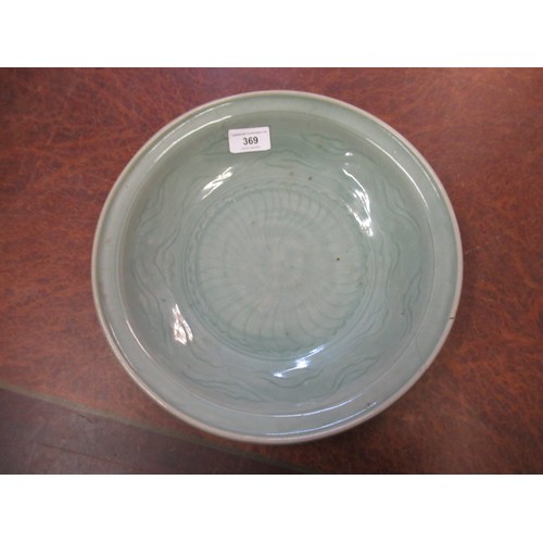 369 - Chinese Celadon circular deep dish with shallow incised decoration, 32cm diameter, with a hardwood s... 