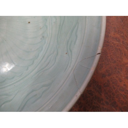 369 - Chinese Celadon circular deep dish with shallow incised decoration, 32cm diameter, with a hardwood s... 