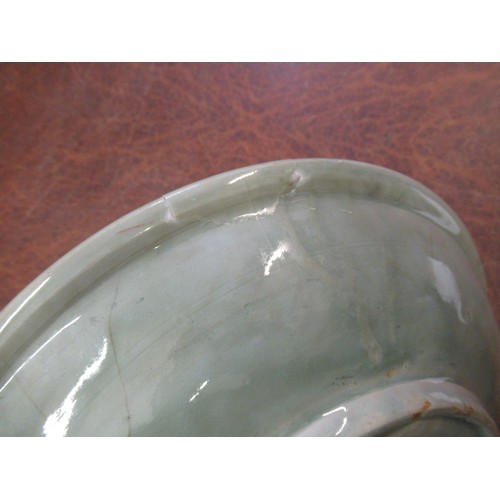 369 - Chinese Celadon circular deep dish with shallow incised decoration, 32cm diameter, with a hardwood s... 