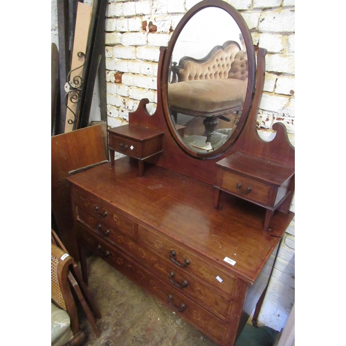 Edwardian mahogany crossbanded and inlaid dressing table, the mirrored back with two jewel drawers above two short and two long drawers, on square tapering supports with casters