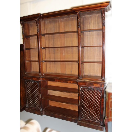 1733 - 19th Century mahogany inverted breakfront bookcase, the moulded cornice above three adjustable shelv... 