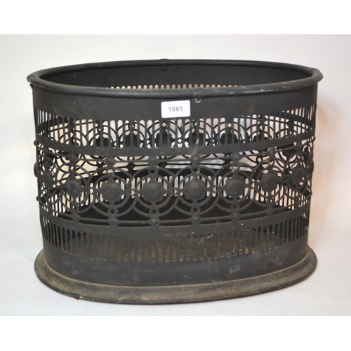 Oval black painted metal log basket of pierced design