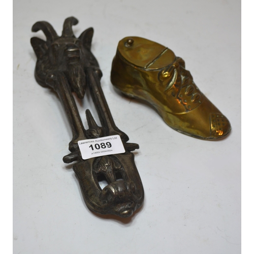 1089 - Patinated iron door knocker in the form of a rams head, 27cm high, together with a brass inkwell in ... 