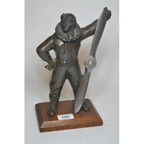 1093 - Mid 20th Century patinated spelter table lighter in the form of an aviator on an oak plinth base, 17... 