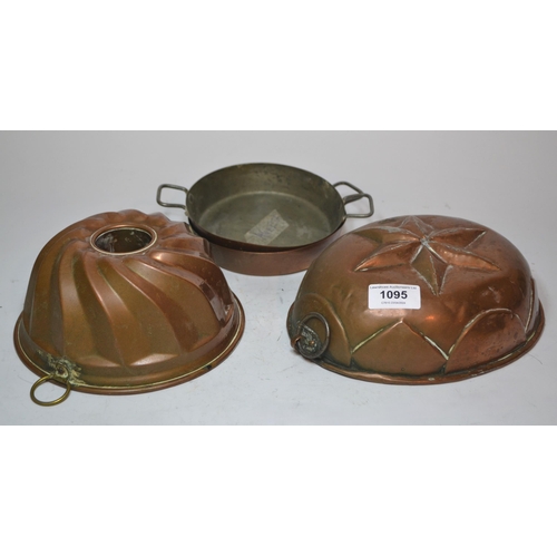 1095 - Two copper jelly moulds and two, two-handled copper saucepans