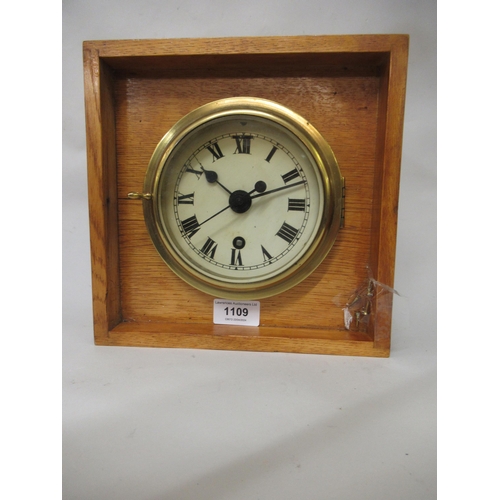 1109 - Ship's circular brass bulkhead clock, the enamel dial with Roman numerals, the single train movement... 