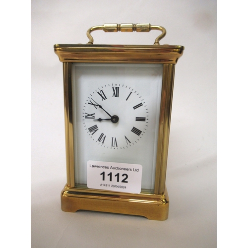 1112 - Modern brass cased carriage clock having enamel dial with Roman numerals, including key, 12cm high