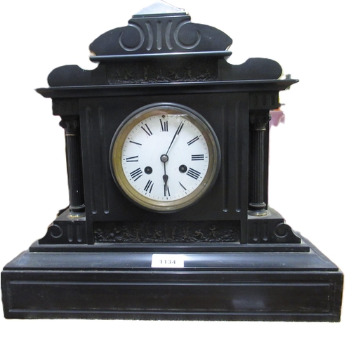 1134 - 19th Century French black slate mantel clock, the enamel dial with Roman numerals and two train move... 