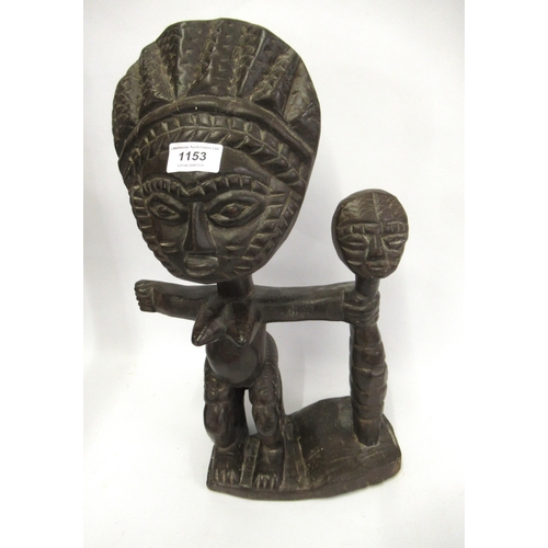 1153 - African native carved hardwood figure with a maskhead staff, 41cm high