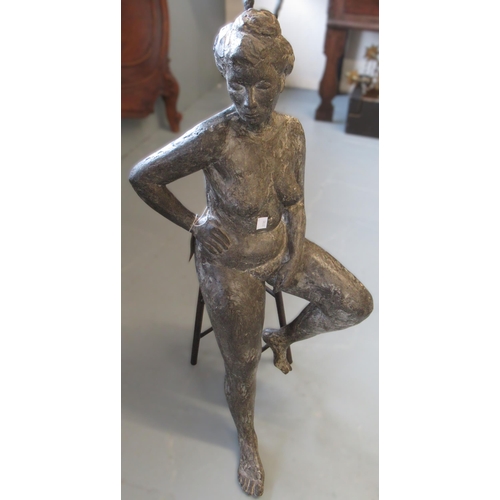 1156 - Modern dark patinated bronze figure of a seated female nude on a stool, 75cm high