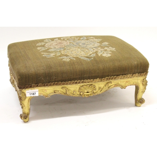 1187 - Small Victorian giltwood footstool with floral decorated top on cabriole supports, 44cm wide