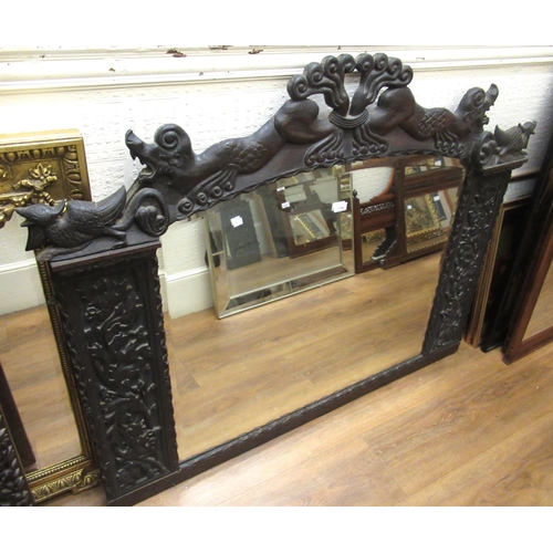 1196 - Large Continental carved oak overmantel mirror, the top surmounted with figures of animals, having o... 