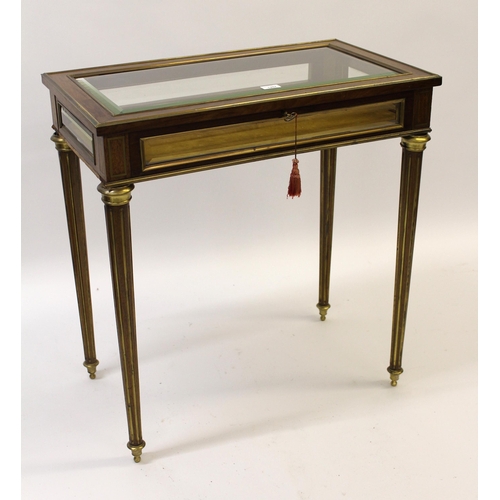 1207 - 19th Century French mahogany and brass mounted bijouterie table with a hinged bevelled glass lid, fo... 