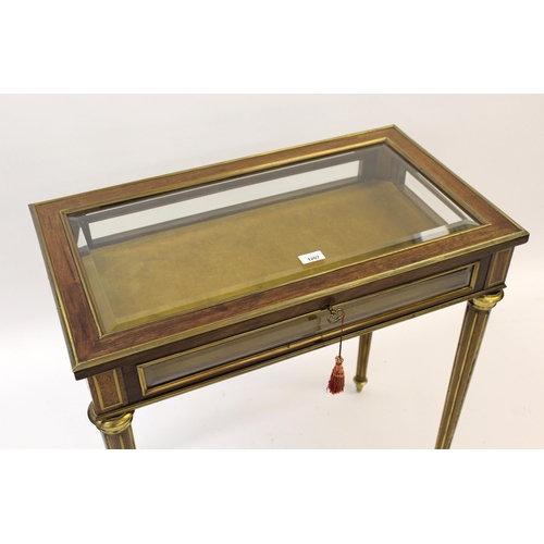 1207 - 19th Century French mahogany and brass mounted bijouterie table with a hinged bevelled glass lid, fo... 