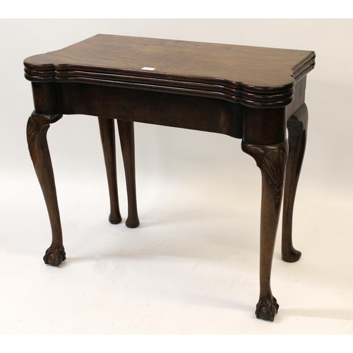 1225 - Mid 18th Century mahogany games / tea table with a triple fold-over top, raised on shell carved cabr... 