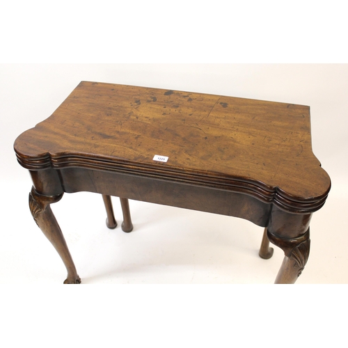 1225 - Mid 18th Century mahogany games / tea table with a triple fold-over top, raised on shell carved cabr... 