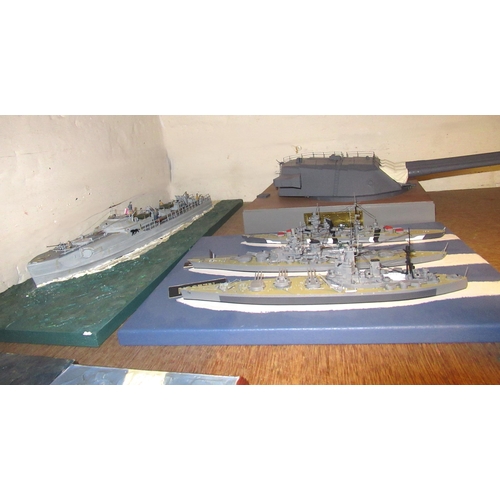 124 - Four large display models of World War II battleships, one with three ships and a display model of Y... 