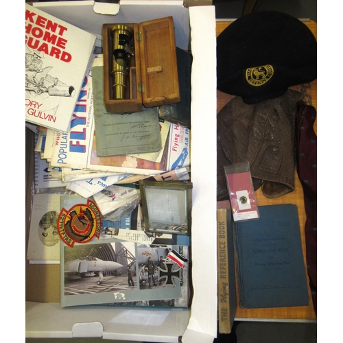 142 - Box containing a quantity of military related items including pilot's log books with entries, leathe... 