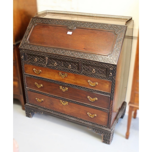 1433 - 19th Century mahogany bureau, the fall front and upper drawers with blind fretwork and conforming fi... 