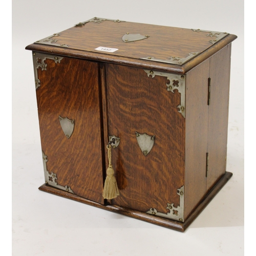 1452 - Early 20th Century oak two door smokers compendium, with silver plated mounts