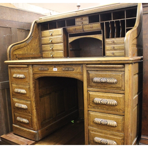 1468 - Good quality oak roll top tambour fronted desk enclosing a fitted interior of various shelves and dr... 