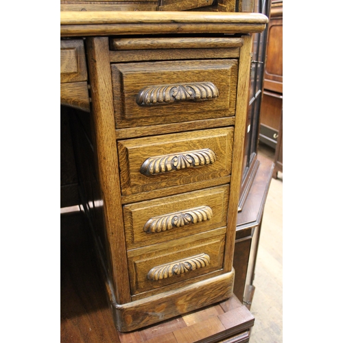 1468 - Good quality oak roll top tambour fronted desk enclosing a fitted interior of various shelves and dr... 