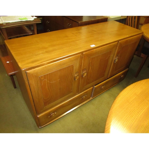 1513 - Ercol light ash sideboard, having three panelled doors with two drawers, on casters, 76cm high x 130... 